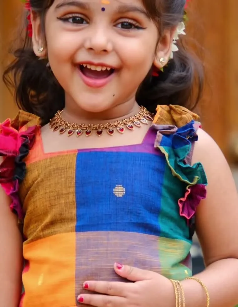 Gautami Gokul — The palakka-style necklace with red stone drops, against the square neckline