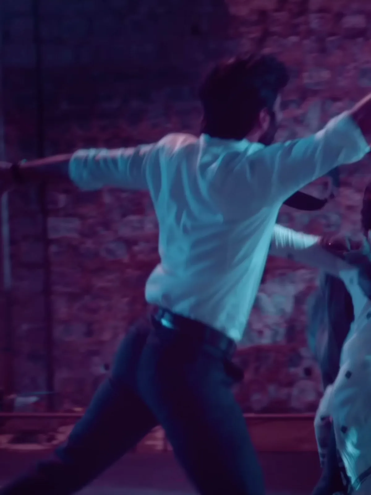 Dhanush — Full length from behind — the dark flat-fronted trousers, straight through the leg