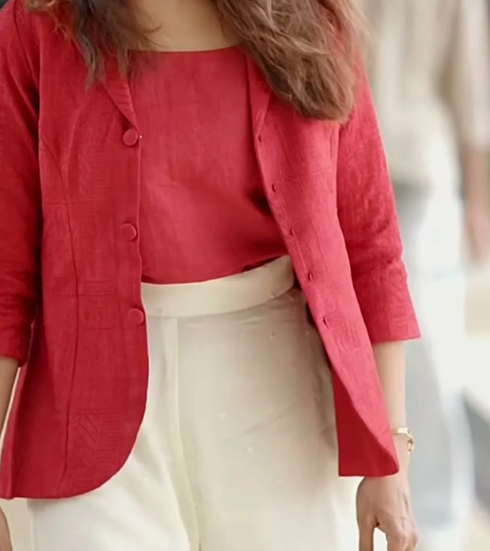 Manju Warrier — Where the two reds meet the ivory: the top ends at the wide waistband, and the bangle shows at the wrist