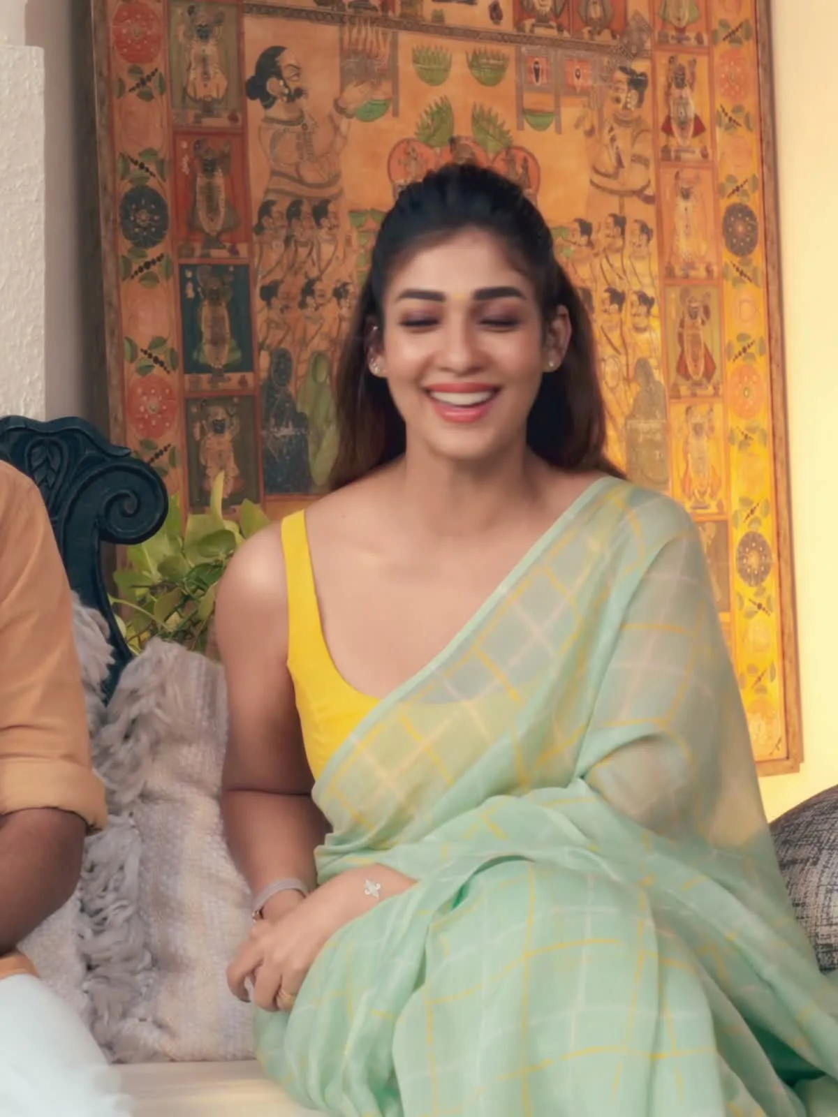 Nayanthara — Seated: the drape over her lap is where the scale of the check reads properly — roughly a hand's width square