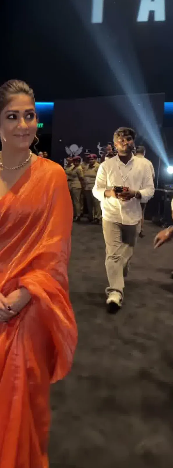 Nayanthara — Full length, walking — the same solid tone runs from the pallu to the hem with no border