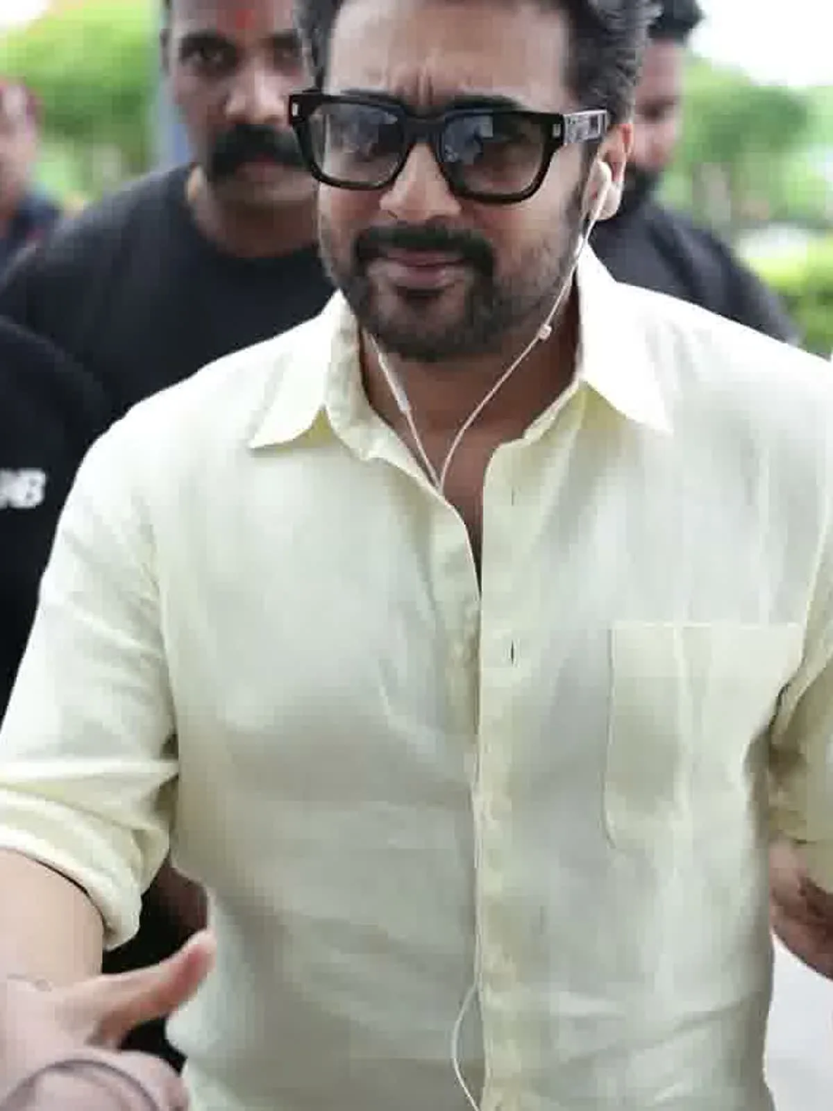 Suriya — Close on the front: point collar on a proper stand, plain placket, and the single plain patch pocket at the left chest