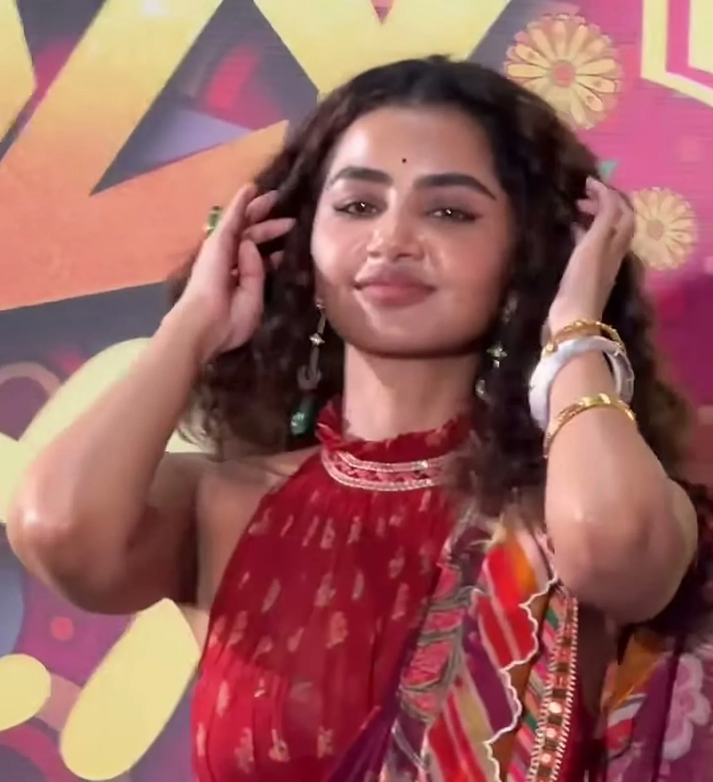 Anupama Parameswaran — The green stone drops, the white watch and the gold chains, all in one frame