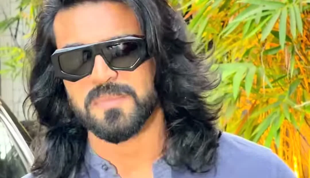 Ram Charan — The sunglasses — heavy black acetate, flat straight brow bar, squared angular lens