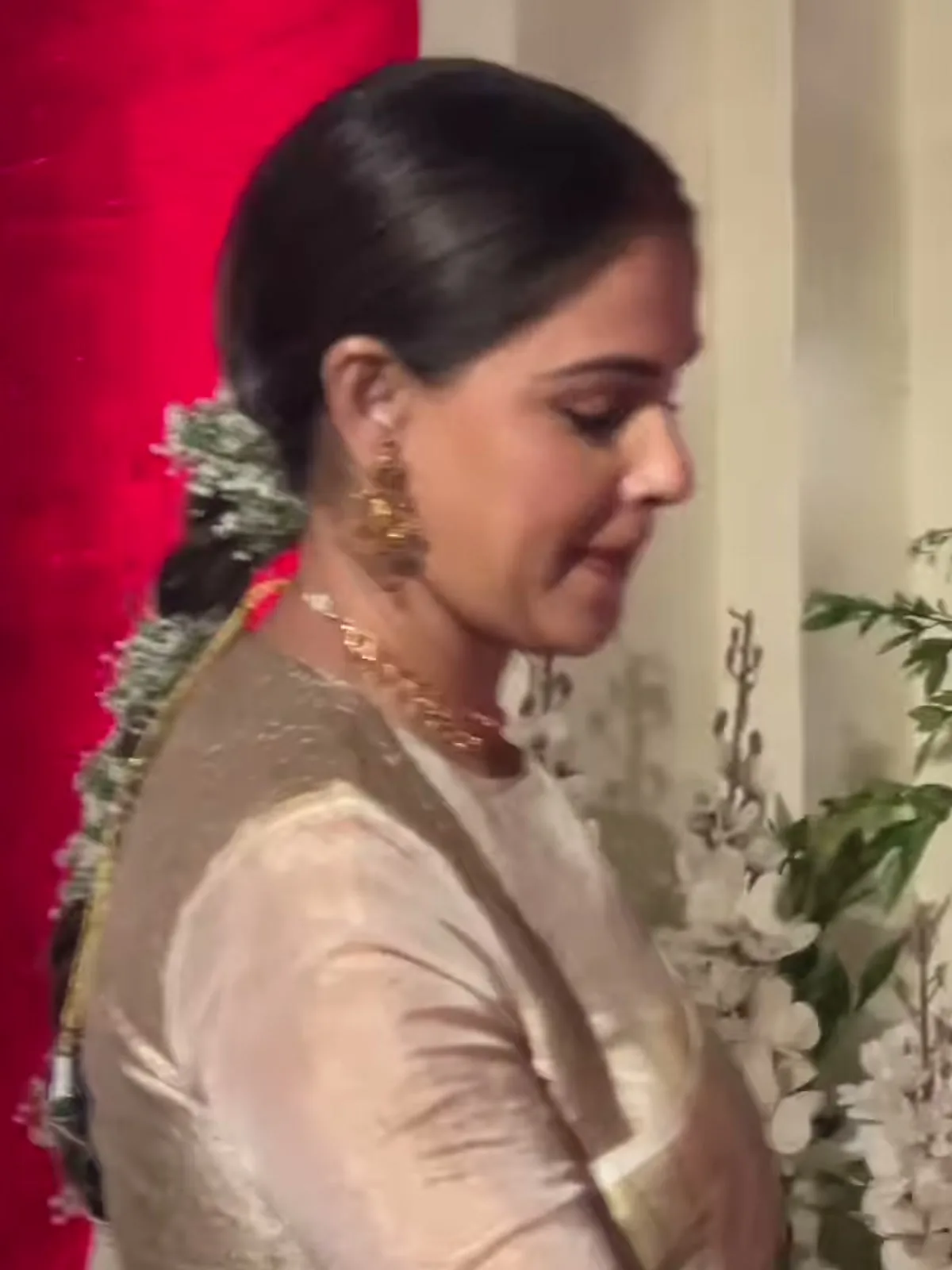 Genelia D’Souza — From behind the shoulder — the strand of fresh white jasmine tucked down the braid, and the broad gold band running along the pallu