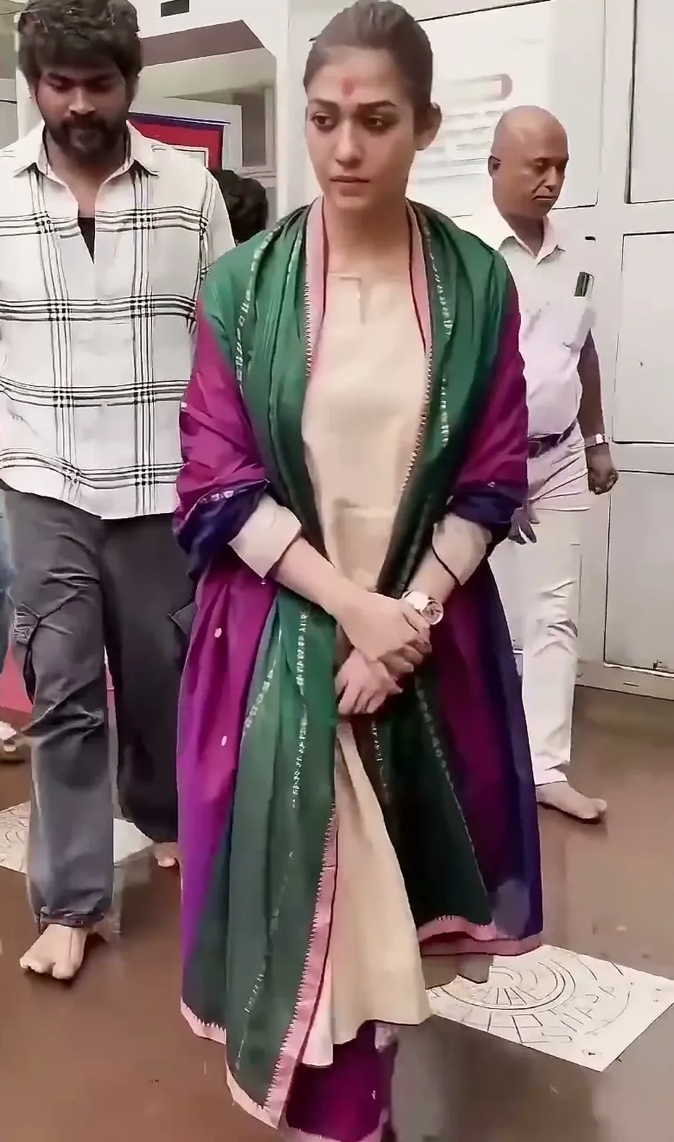 Nayanthara — Full length, walking out with Vignesh Shivan — the deep magenta pants show below the kurta hem
