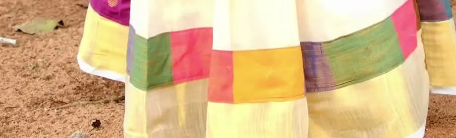 Gautami Gokul — The hem — a multicolour patchwork border in joined woven pieces above a broad gold kasavu band