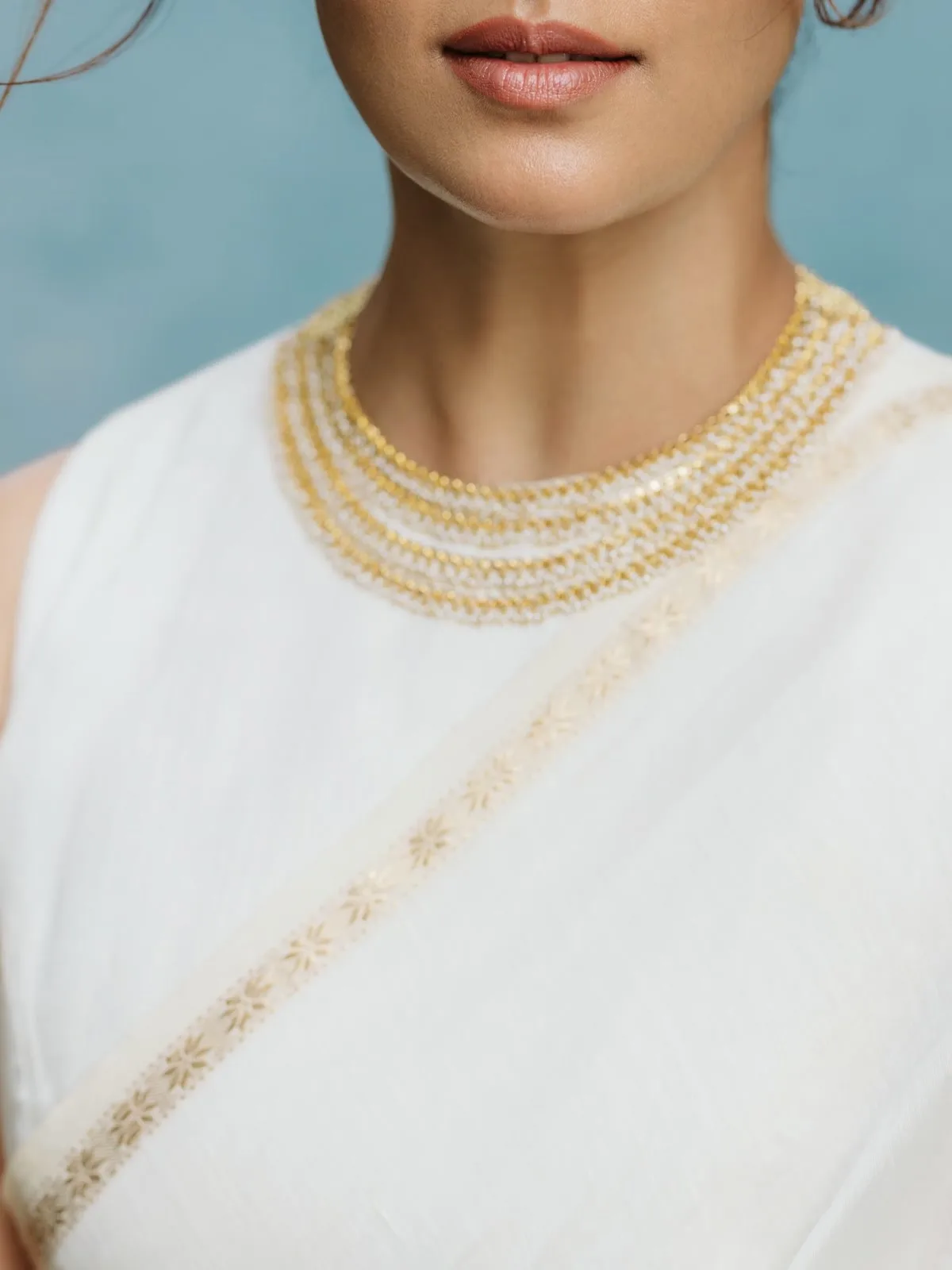 Nayanthara — Close in — seven strands of gold beads threaded with white pearls, and the small star motif woven into the zari band