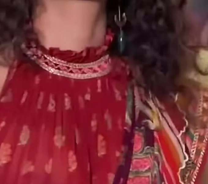 Anupama Parameswaran — Close on the neckline: the ruffle, then the gold-and-cream zig-zag lace band under it