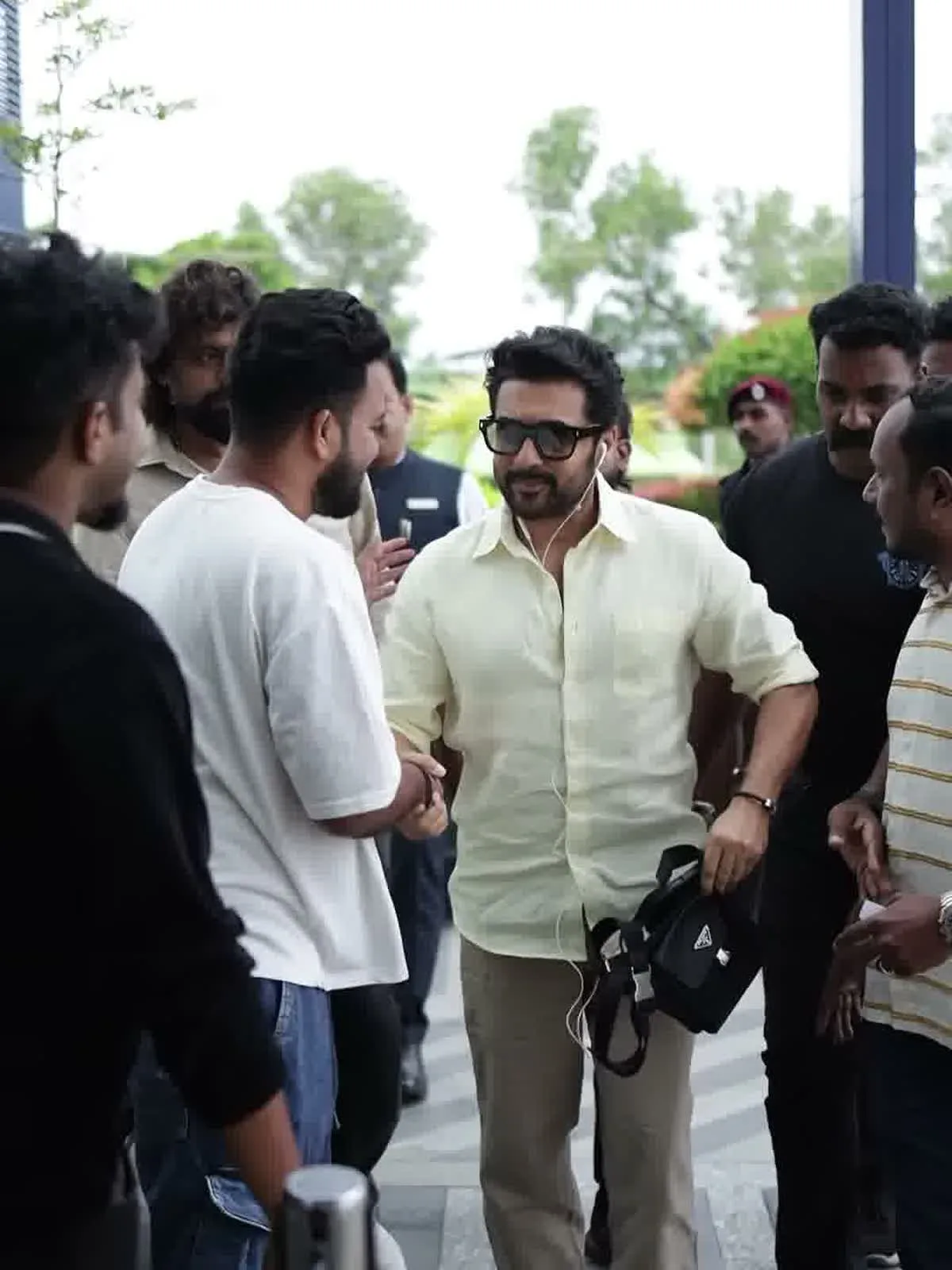 Suriya — Full length, arriving — the straight leg of the chinos and how the shirt falls over them