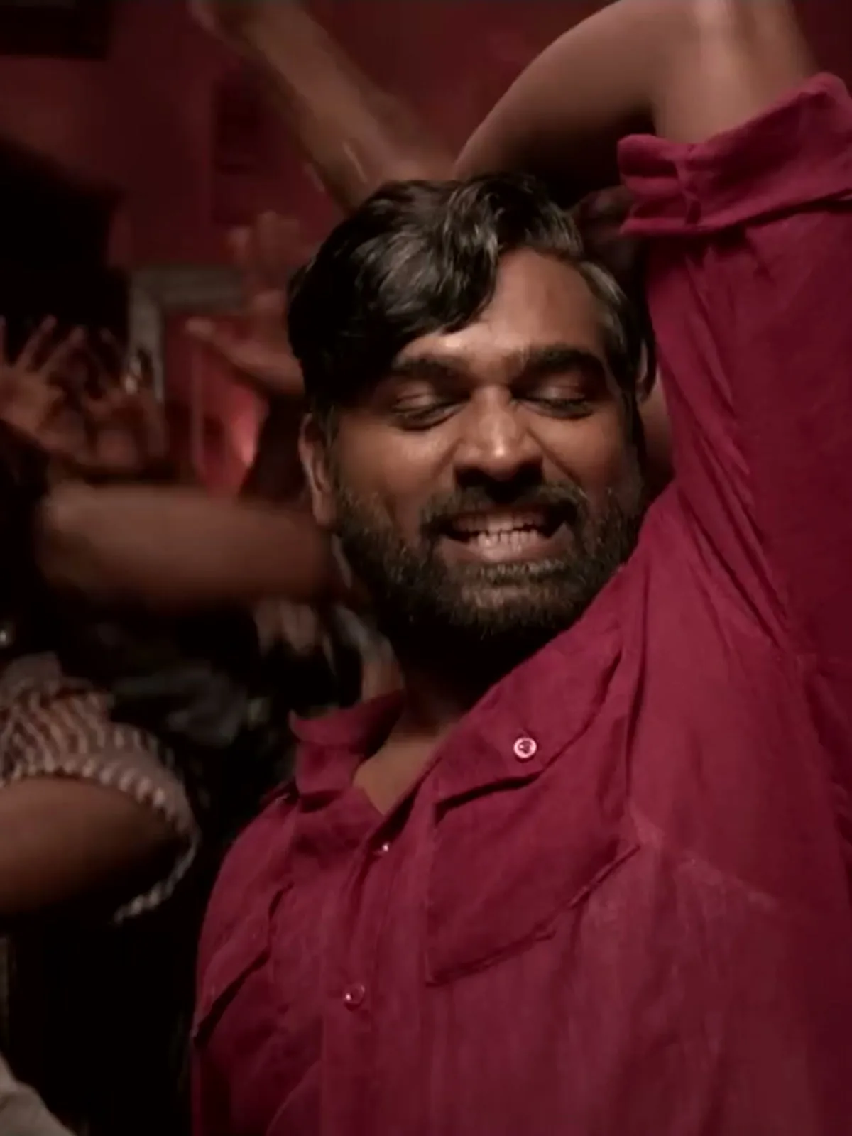 Vijay Sethupathi — Arms up: the sleeve pushed to the elbow, and the right chest flap pocket