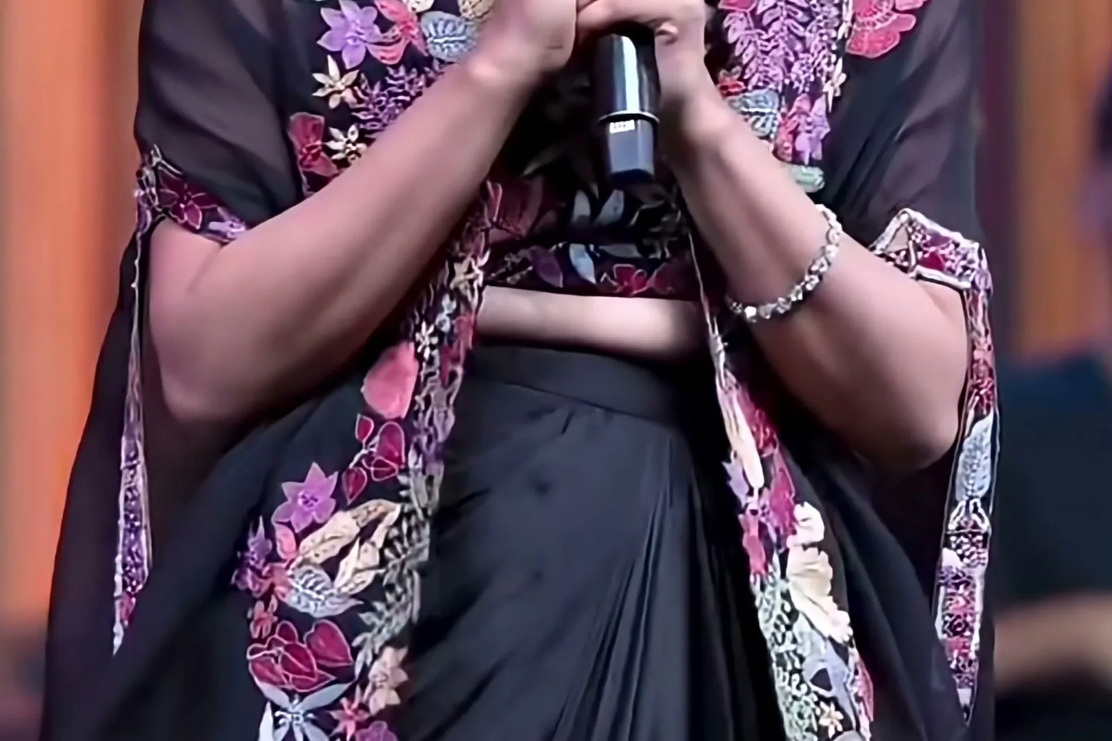 Mamitha Baiju — The waist down: bare midriff between the bustier and the plain, unembroidered satin skirt