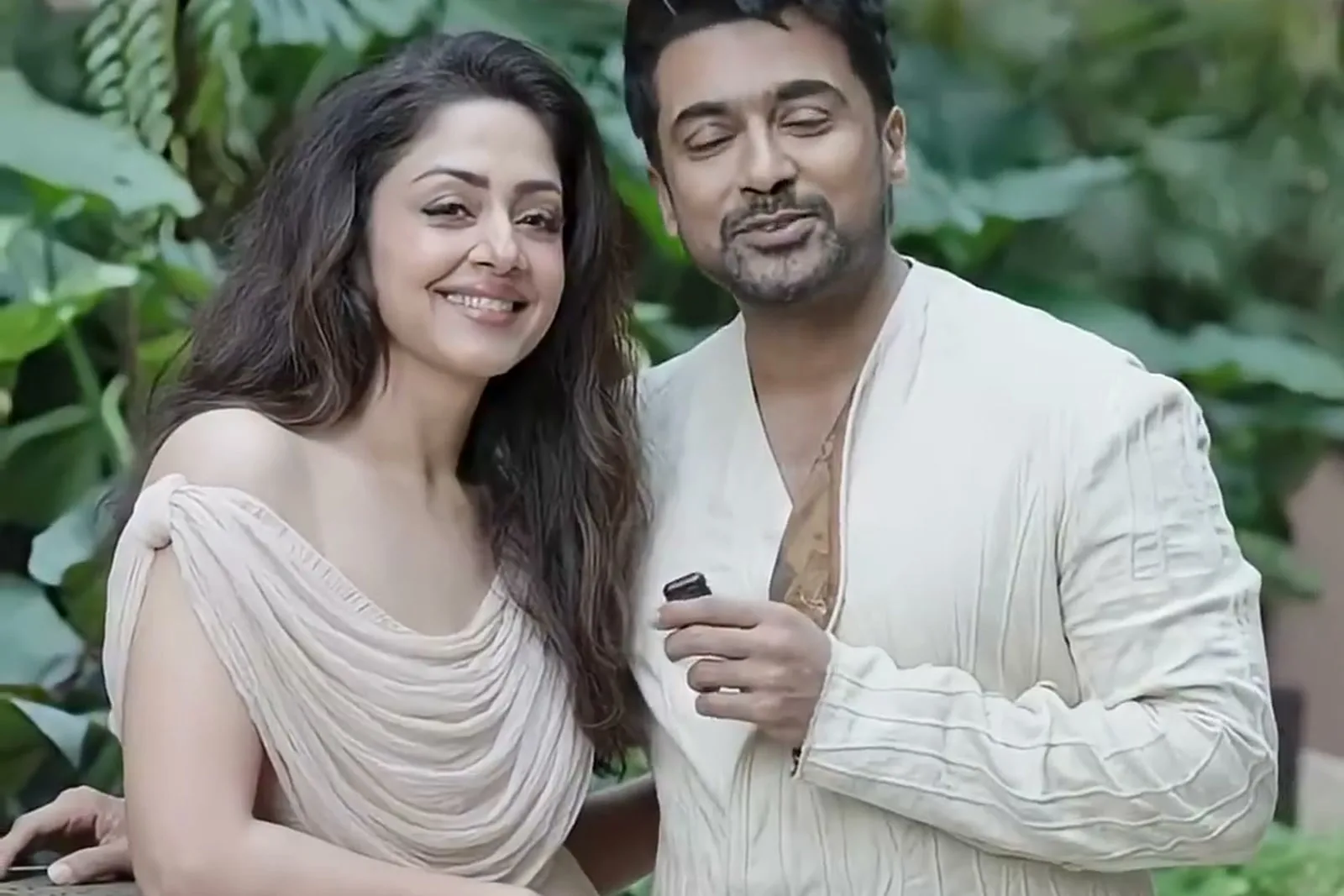 Jyothika — At the stone ledge with Suriya — his crumpled ivory against her nude, which is the whole styling idea of the shoot