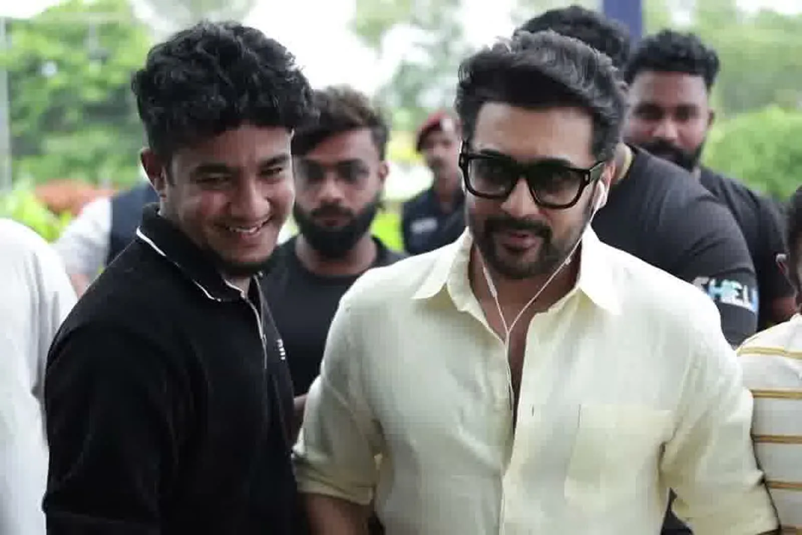 Suriya — The heavy squared black sunglasses he wears throughout
