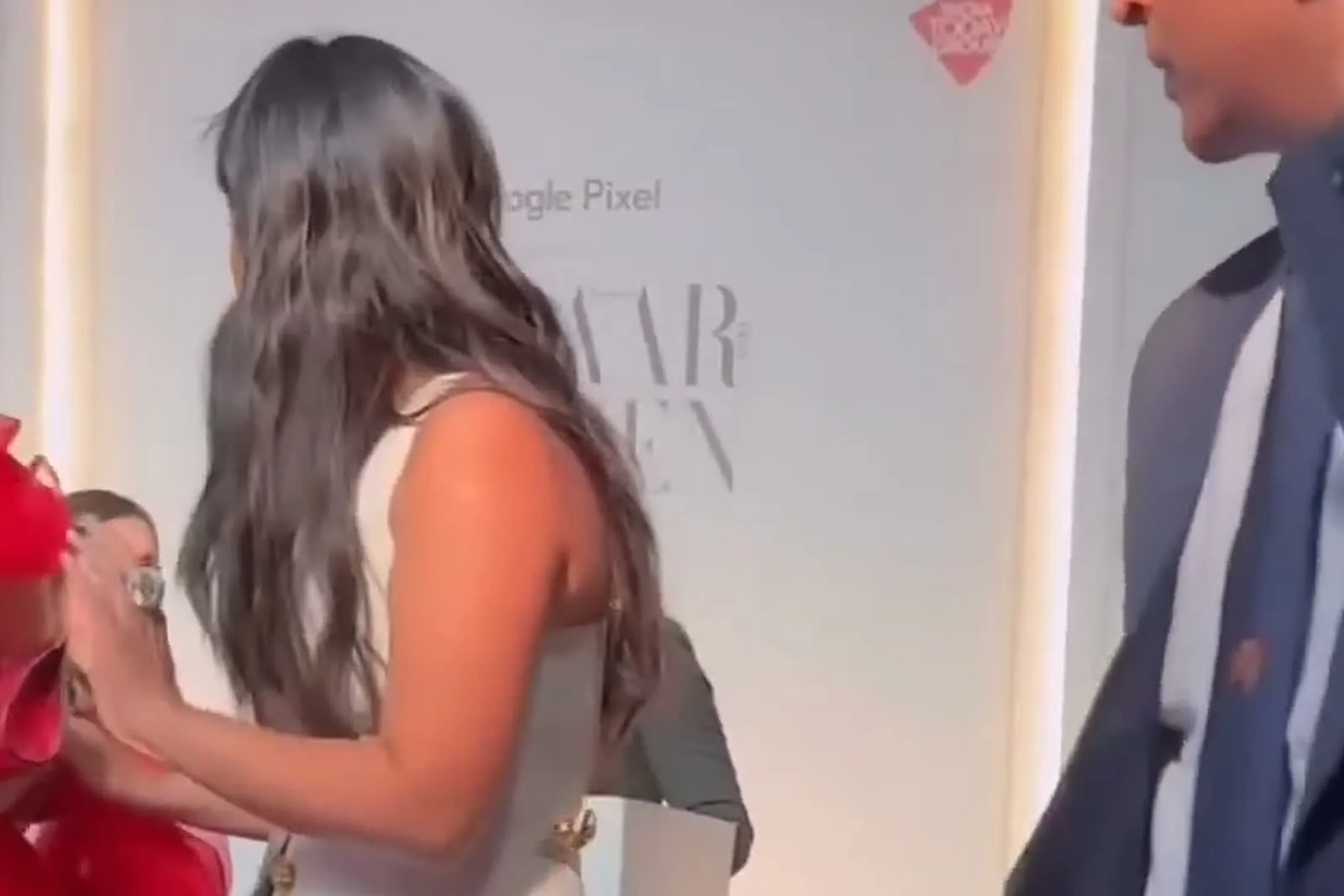 Isha Ambani — Side on against the Women of the Year backdrop — the one angle that dates the look
