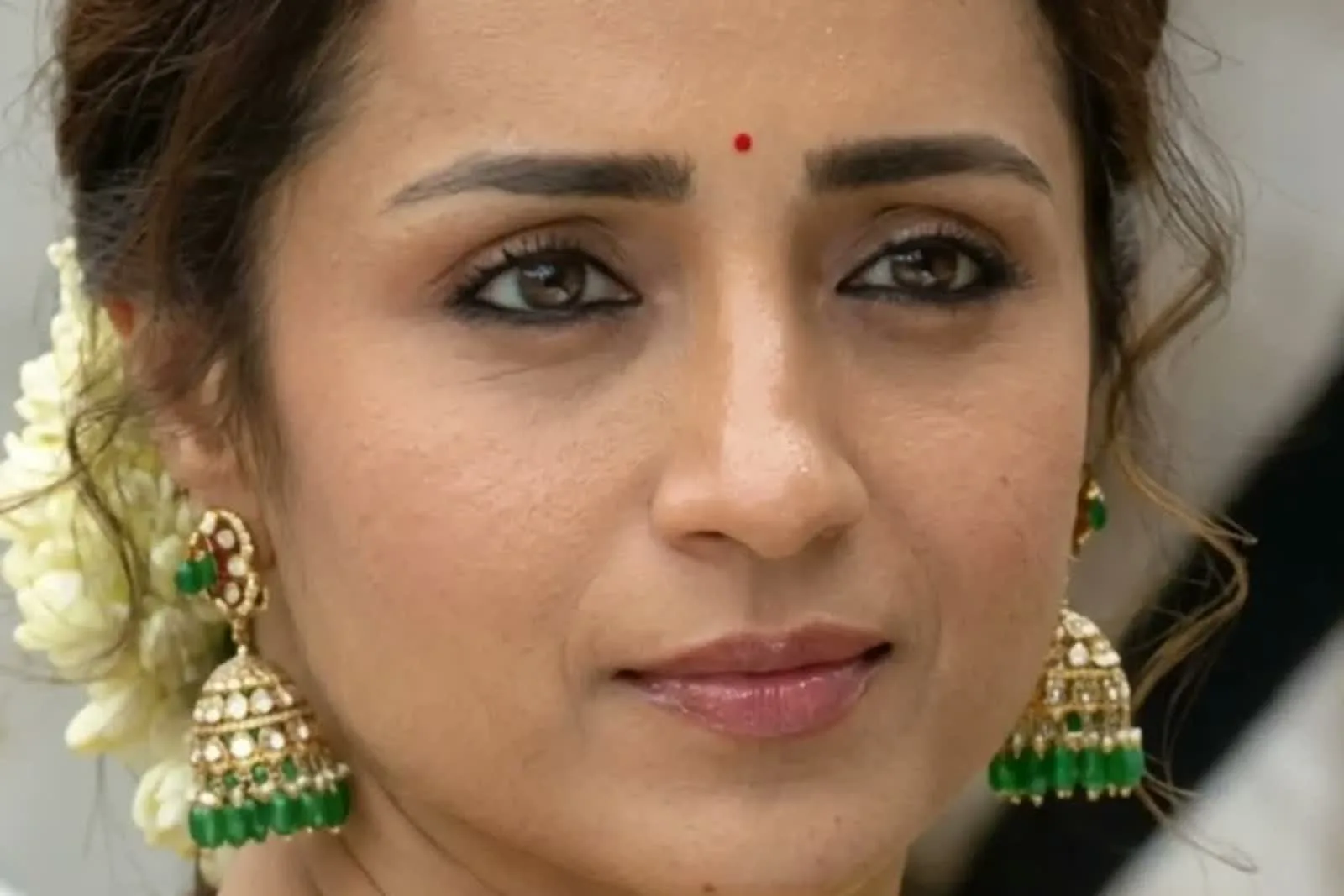 Trisha Krishnan — Head on — the jasmine braid, the small red bindi, and both jhumkas