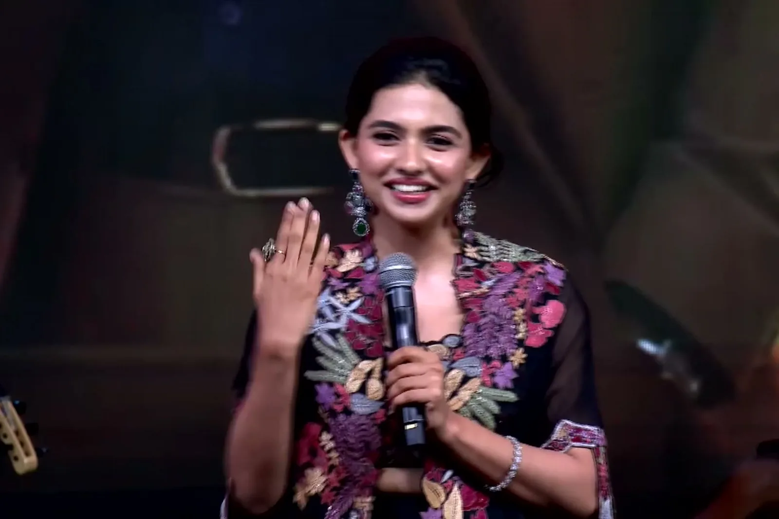 Mamitha Baiju — On stage at the audio launch — the elbow-length gathered sleeve and its embroidered cuff band