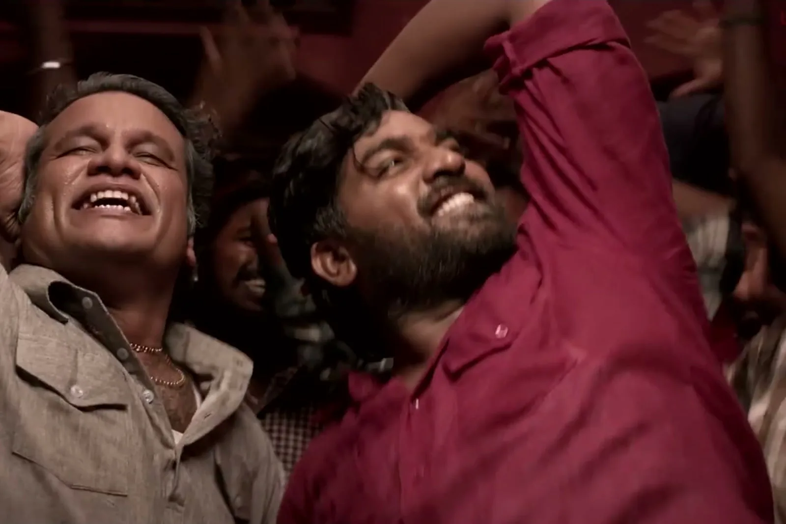 Vijay Sethupathi — Mid-song, close: the creasing across the body that never goes away