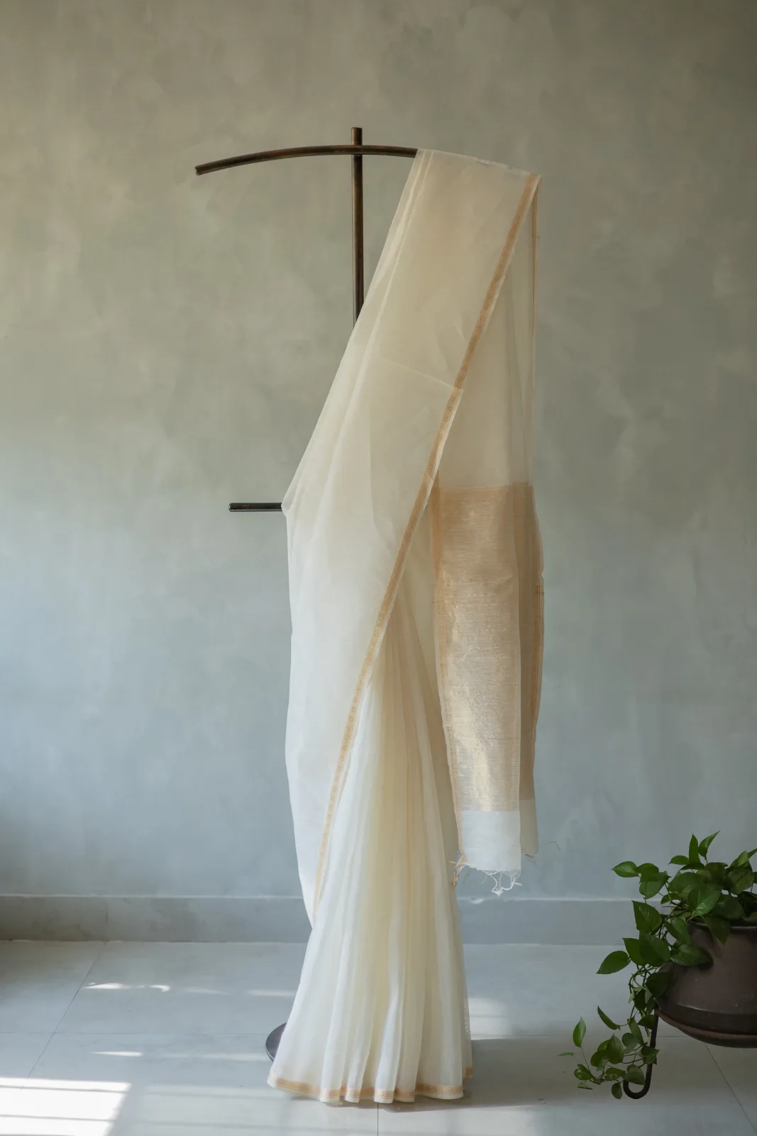 White silk-linen saree with a small gold zari border