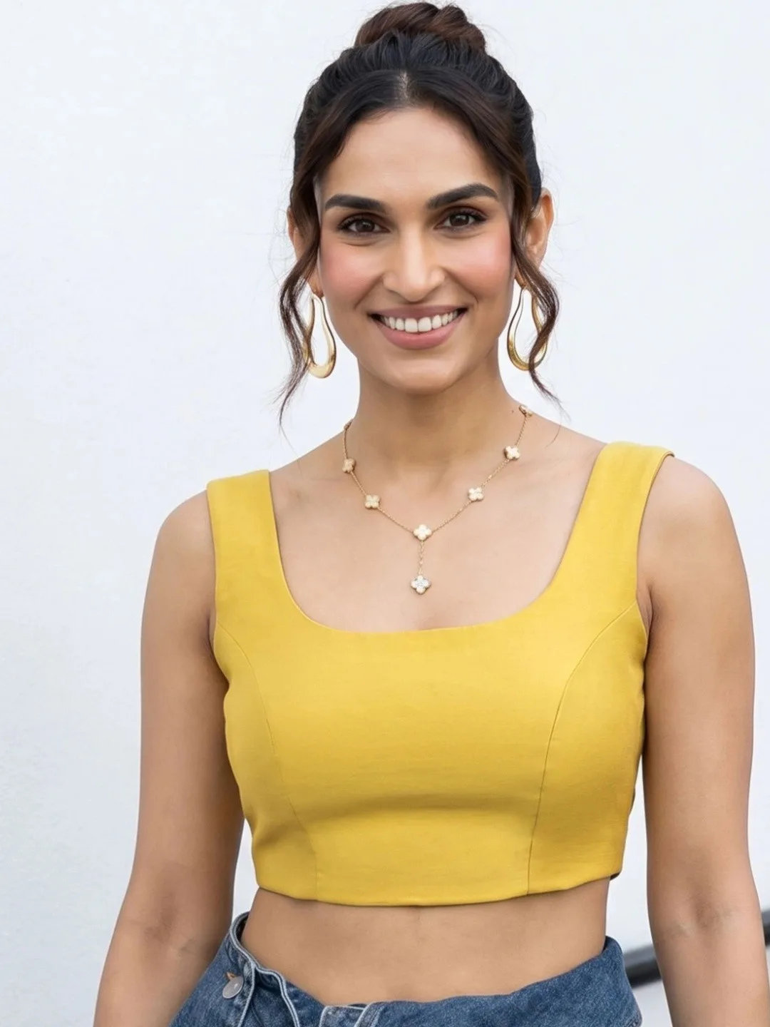 Our pick under ₹700 — plain mustard sleeveless blouse, round neck