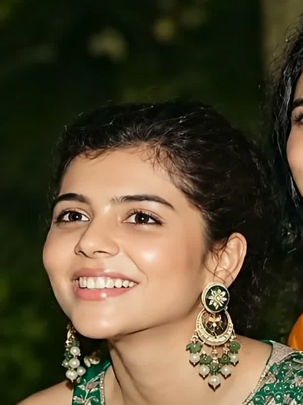 Kalyani Priyadarshan — Close on the chandbalis: green enamel stud, gold crescent, green-and-pearl fringe