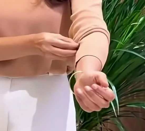 Manju Warrier — The single plain gold bangle at the wrist, and the trouser waistband below