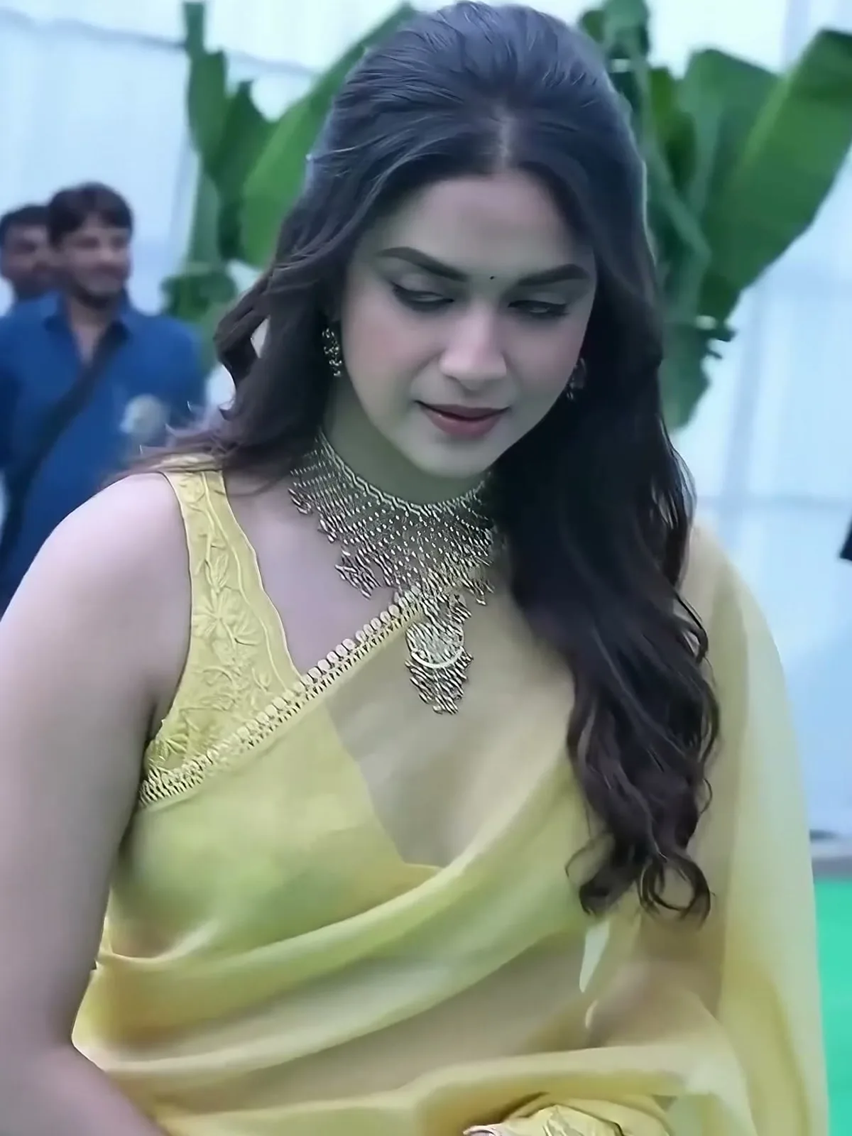Keerthy Suresh — The drape, held: the scalloped trim of small flat gold discs runs the whole edge of the pallu
