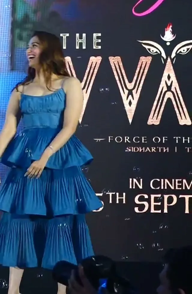 Tamannaah Bhatia — Full length against the backdrop — the tie belt at the natural waist and where the hem finishes