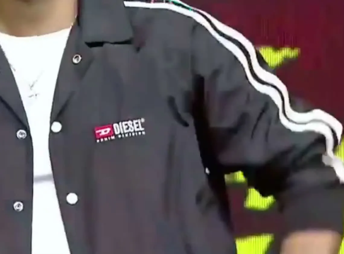 Jason Sanjay — Close on the chest — DIESEL over DENIM DIVISION in white on red, and the stud spacing down the front