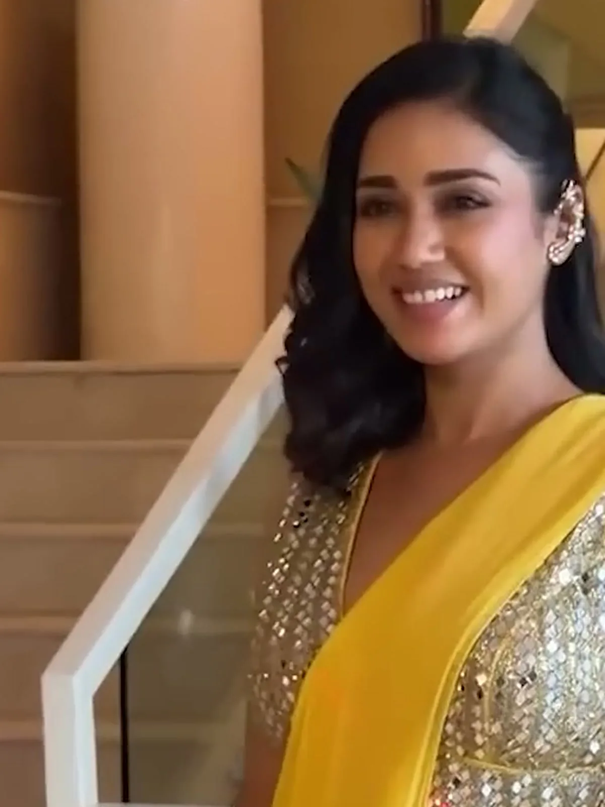 Nivetha Pethuraj — On the hotel stairs, gold ear cuff on the right ear