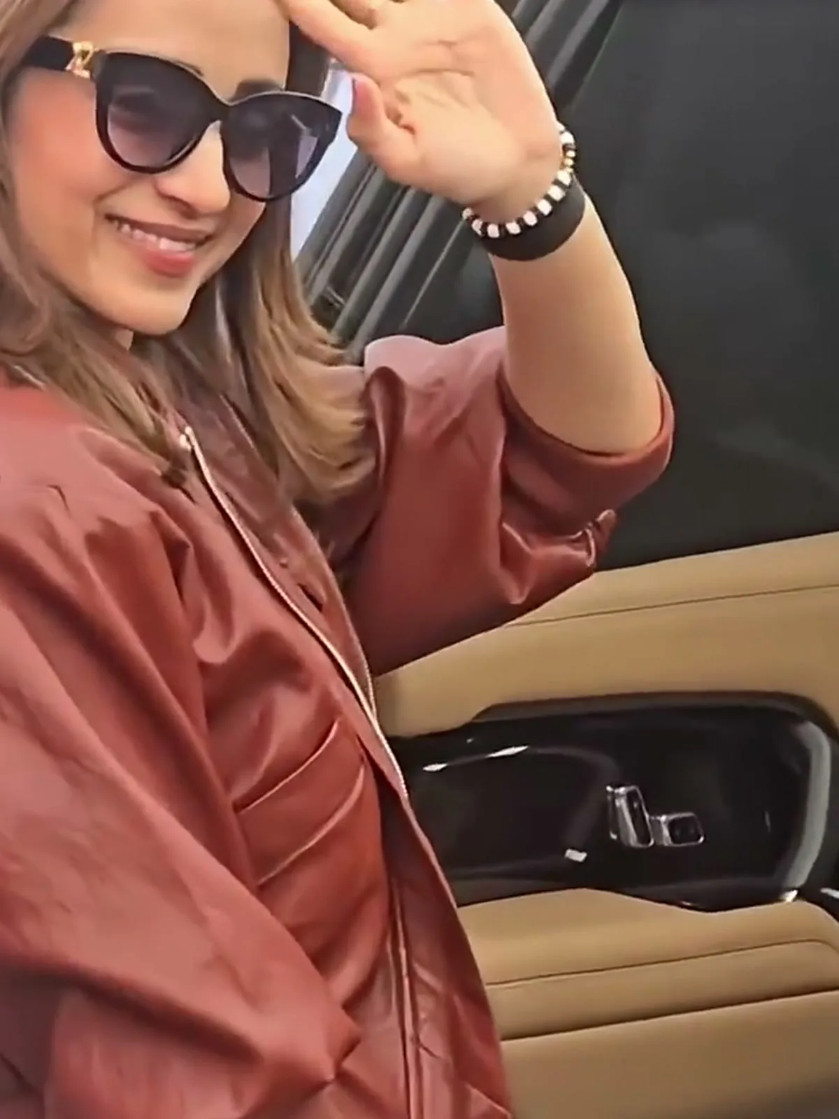 Trisha Krishnan — The blouson sleeve and padded shoulder, and the gold hardware on the cat-eye sunglasses