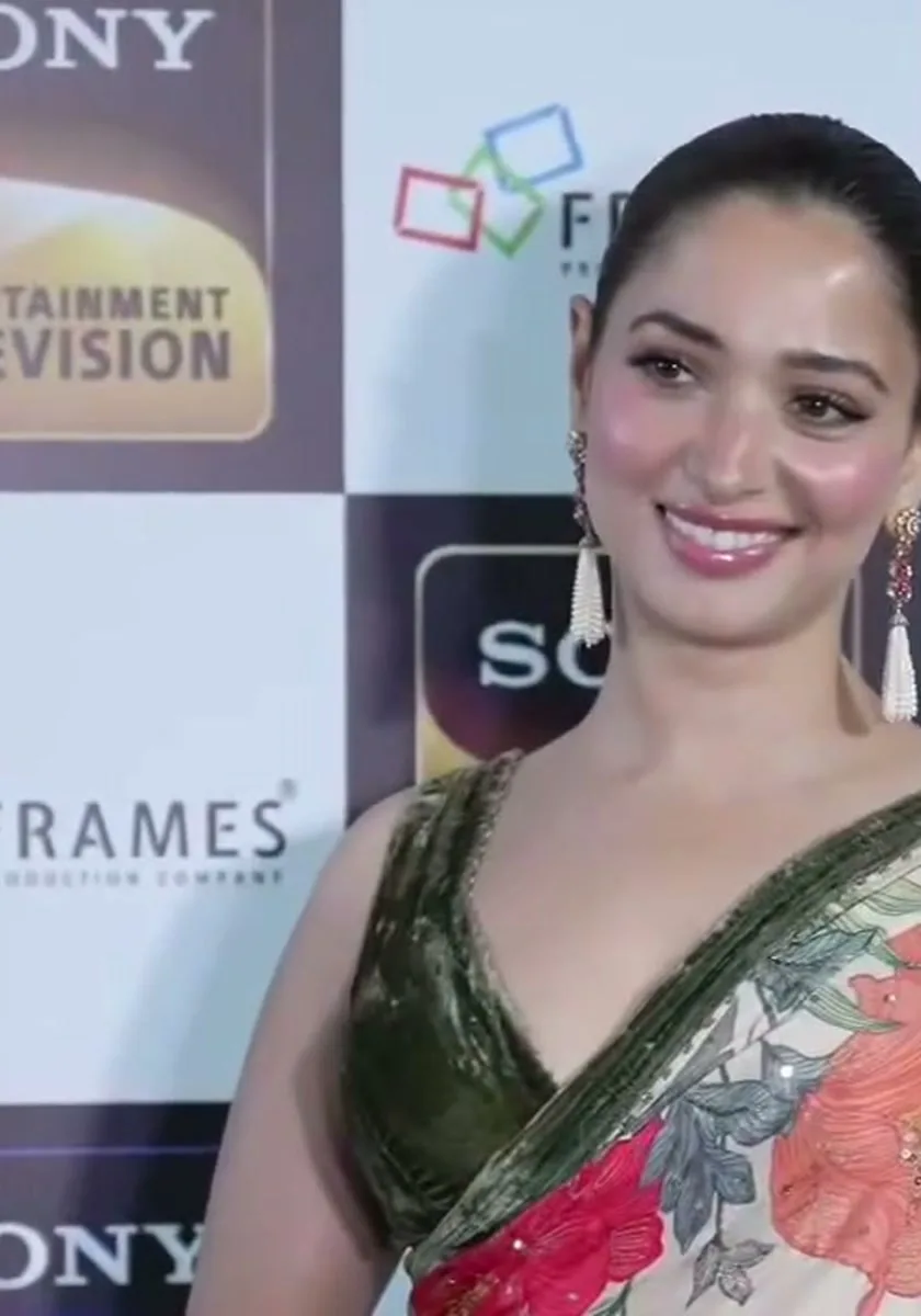 Tamannaah Bhatia — Pink-stone and pearl-tassel earrings, hair in a low bun