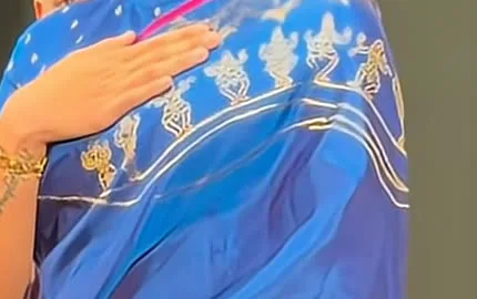 Rashmika Mandanna — Gold zari dancing figures walking along three sweeping curves of gold