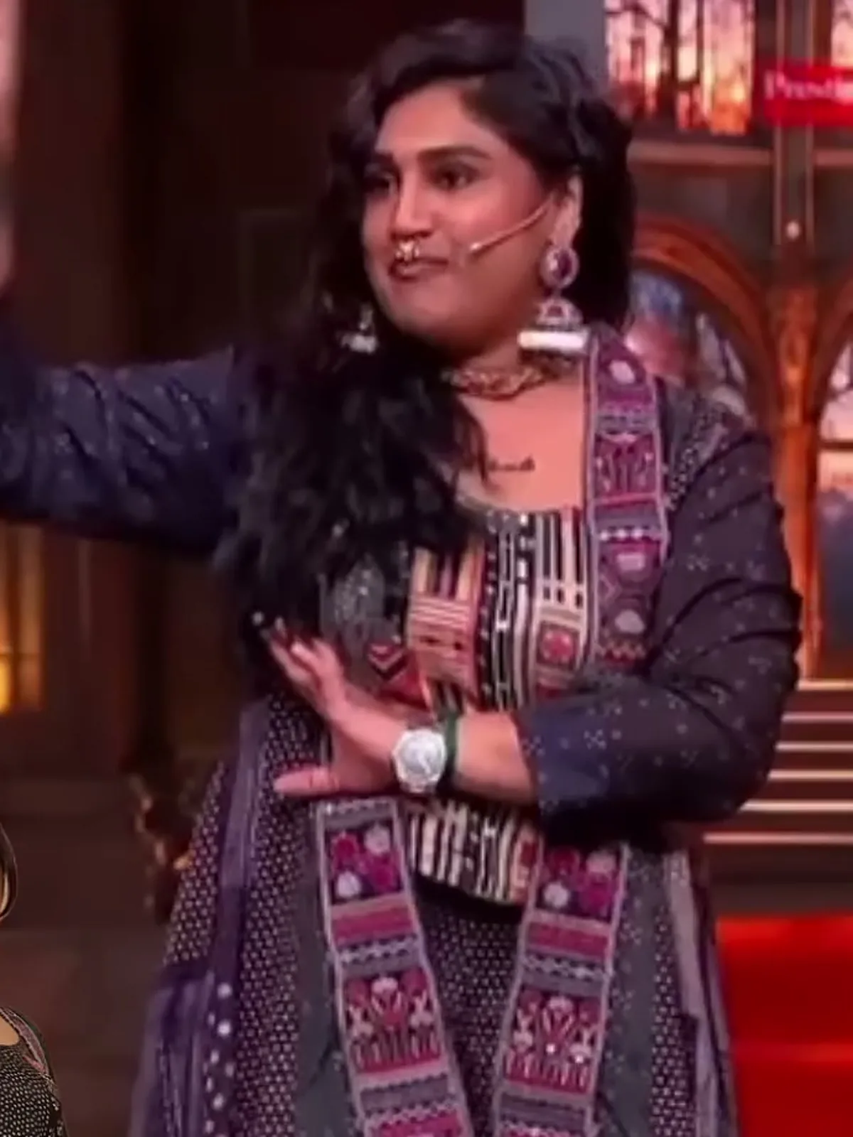 Vanitha Vijayakumar — On her feet — the jacket runs floor length and the embroidered band runs the full front edge with it