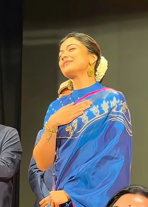 Rashmika Mandanna — The whole drape on stage — cobalt silk with the magenta line along the pallu edge