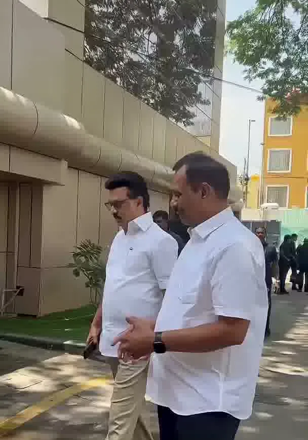 Vijay — Side profile, closer — the spread collar and the shirt worn tucked in with a belt