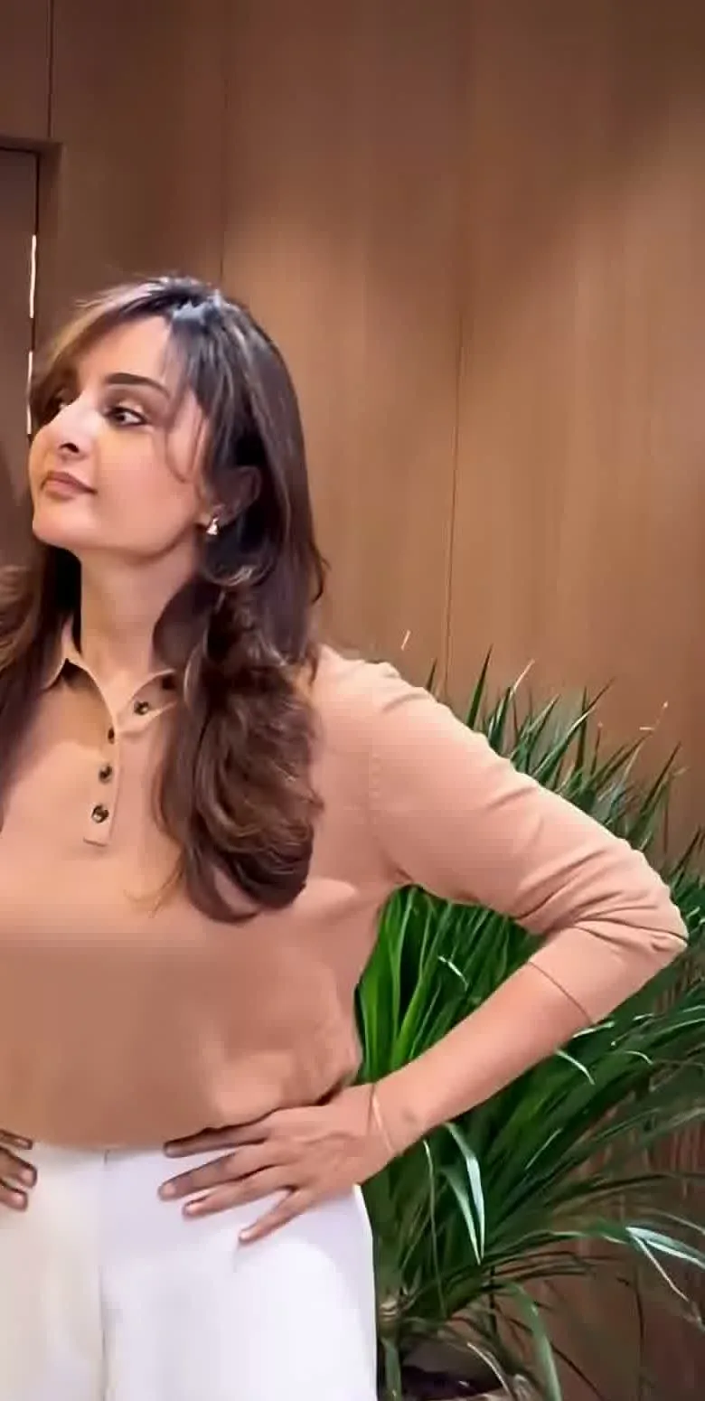 Manju Warrier — The whole outfit — the camel jumper tucked into ivory wide-leg trousers