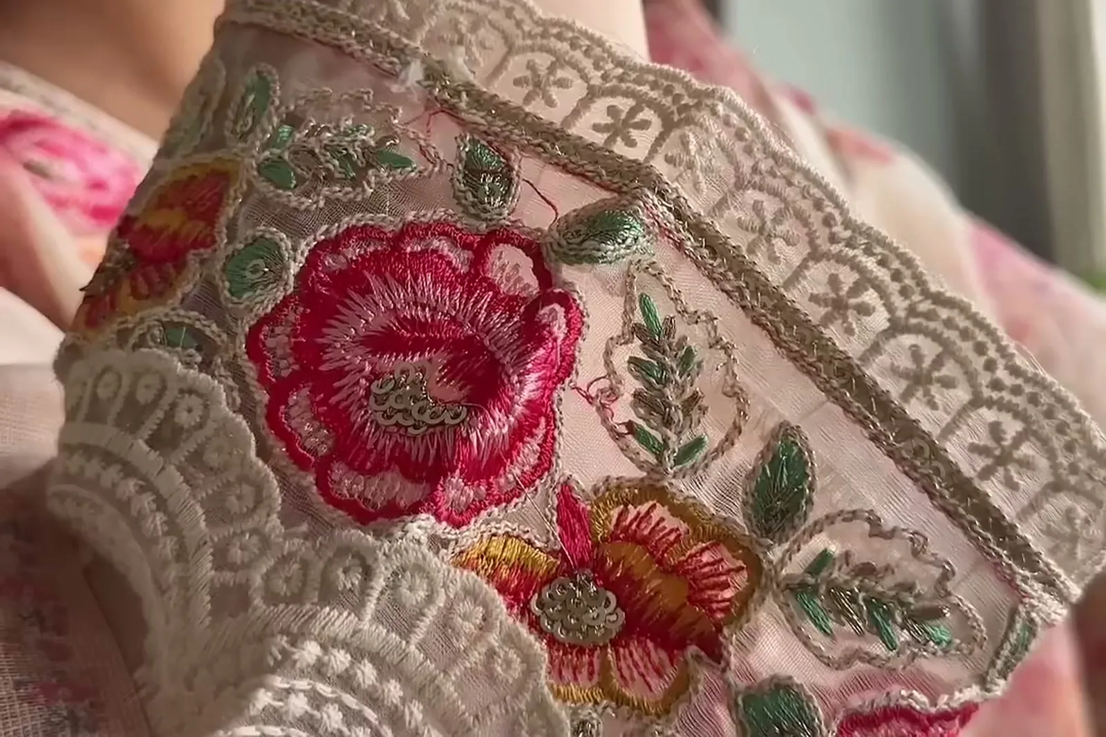 Manika Dhingra — The sleeve: a wide scalloped lace cuff with embroidered roses