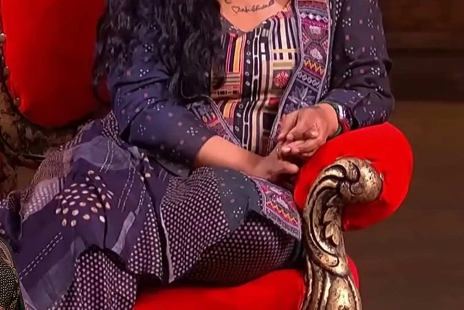 Vanitha Vijayakumar — Seated, waist down — the organza panel against the wide leg of the pants