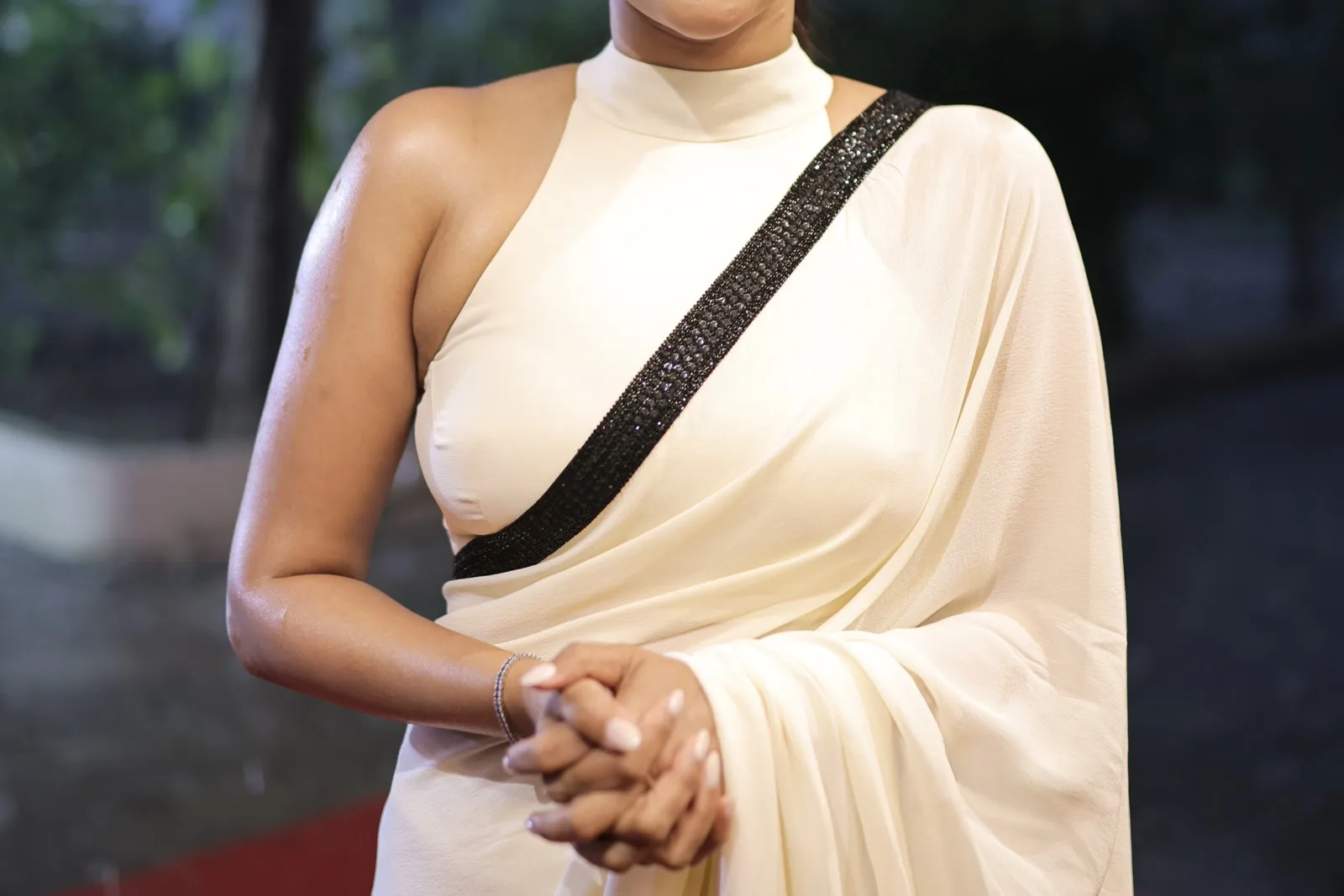 Aishwarya Lekshmi — The evening frames, close — the beadwork throwing individual points of light against matte cream