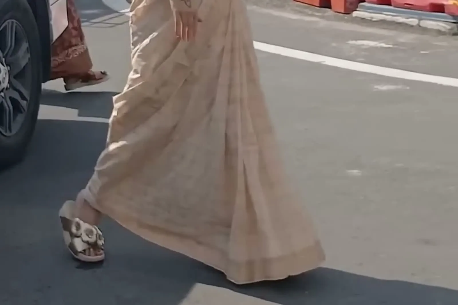 Kanimozhi Santhosh — The slides at the hem — cross vamp, layered leather flowers, flat cushioned sole