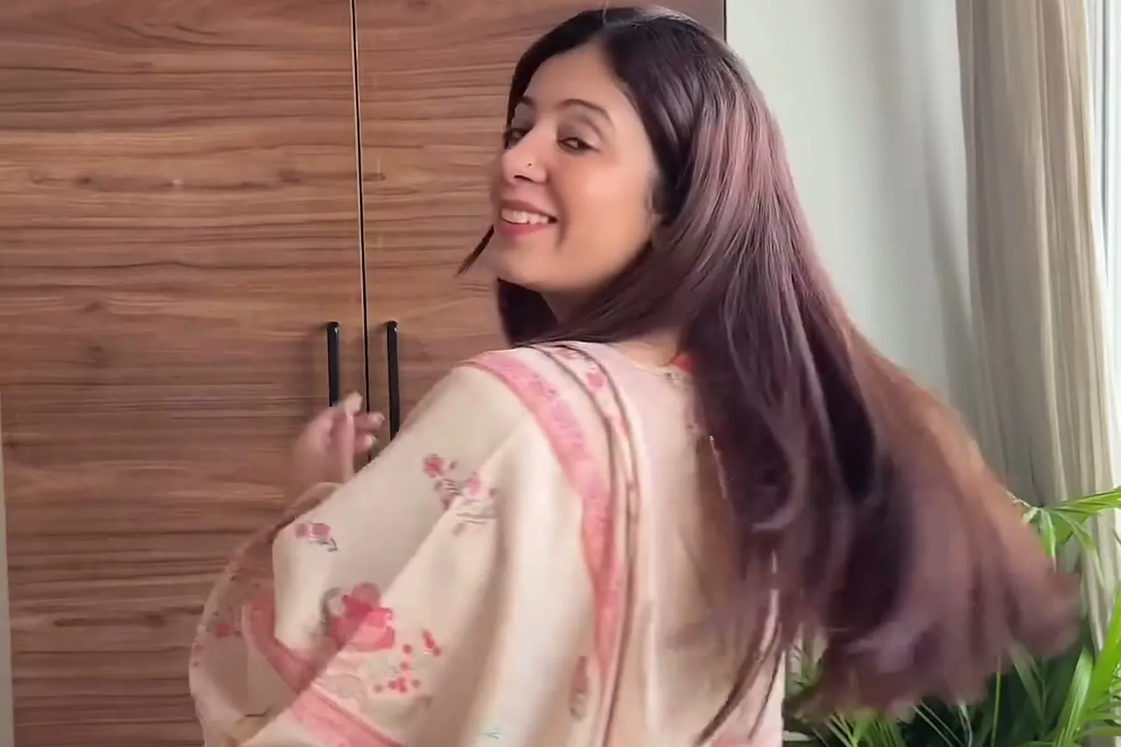 Manika Dhingra — Turning away: the dupatta’s pink border over the shoulder