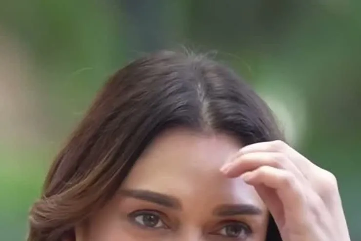 Aditi Rao Hydari — Candid, arriving — the sleeveless V-neck and the asymmetric placement across the front