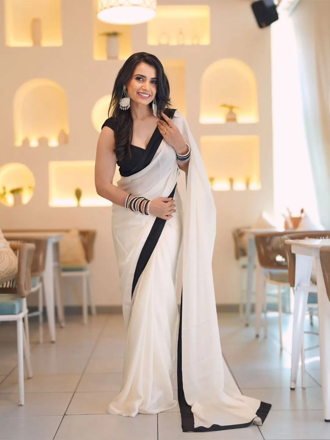 ARPITA FASHION Ivory crepe saree with a black border
