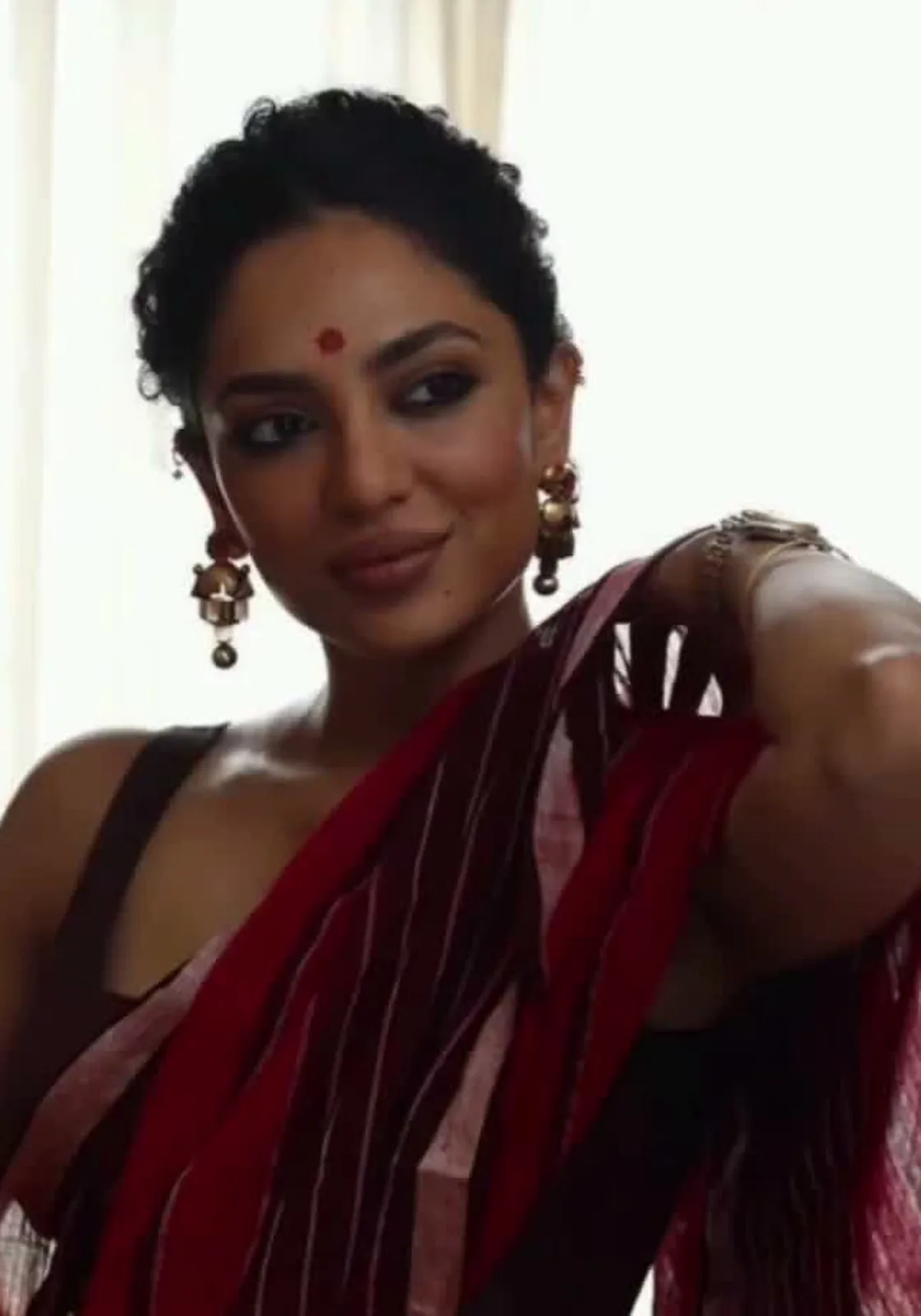 Sobhita Dhulipala — The pallu over her shoulder, maroon barred with pale gold