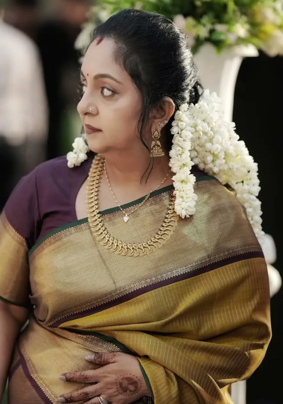 Sindhu Krishna — In profile — the wine blouse with the gold border at the sleeve