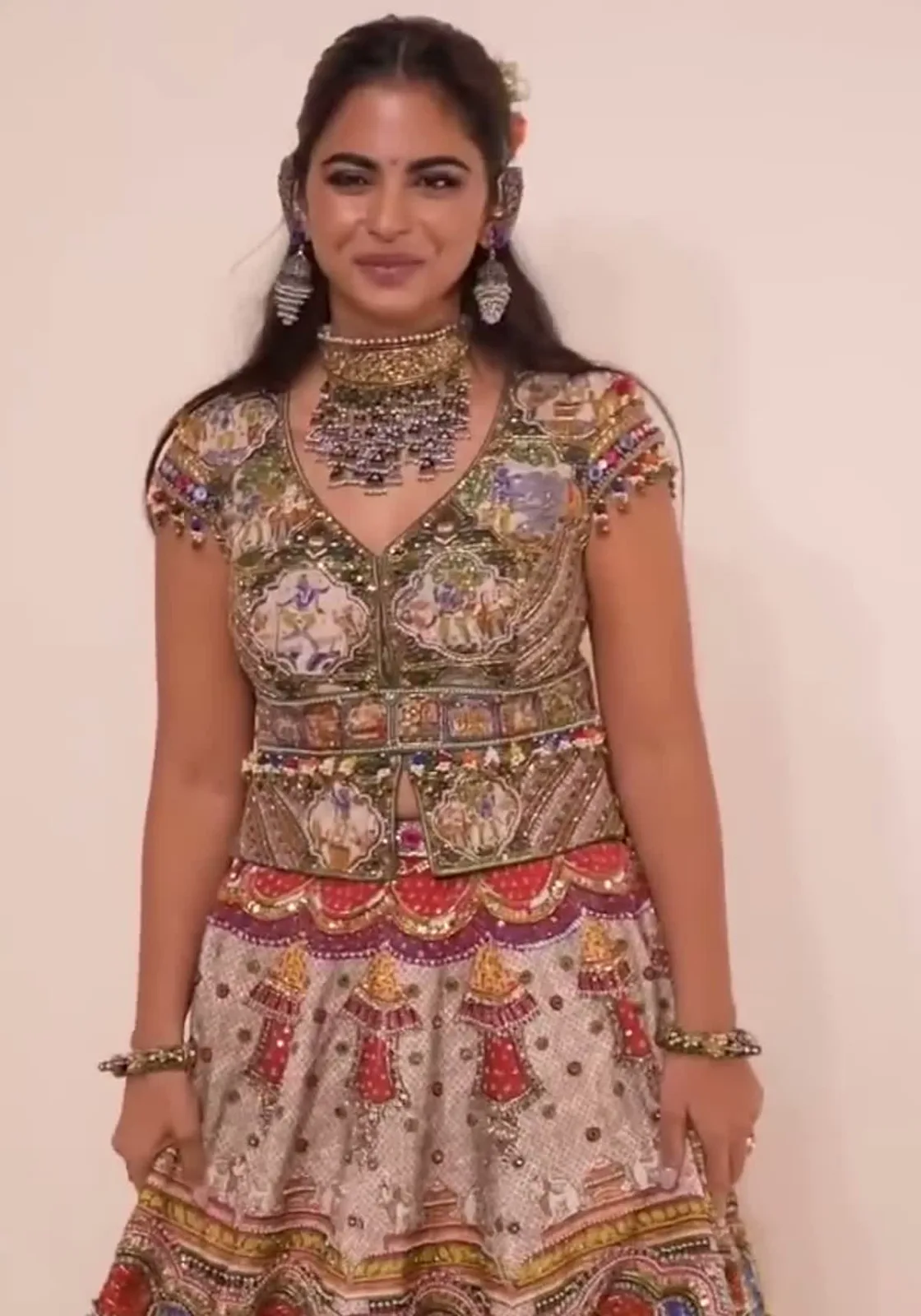 Isha Ambani — Facing the cameras: the painted choli, the tasselled peplum and the Kalamkari skirt