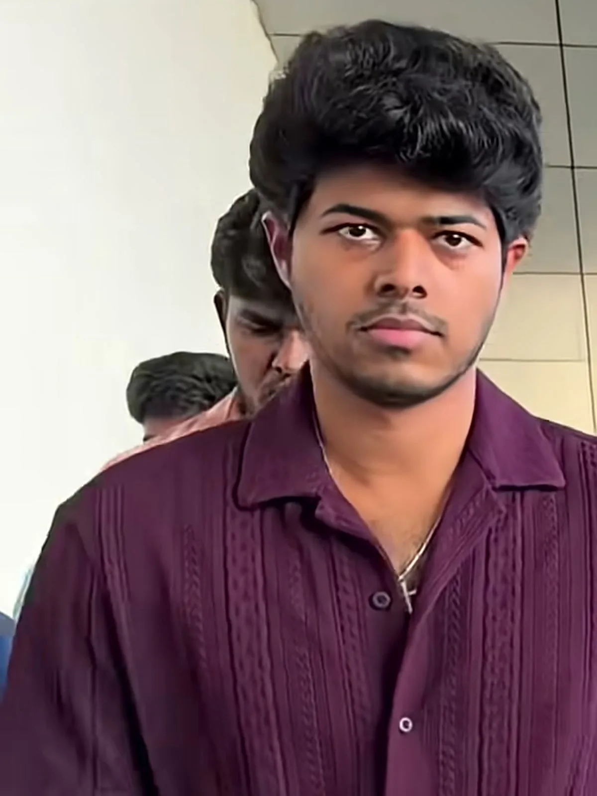 Jason Sanjay — A step later: the aubergine purple in flat daylight, and the thin chain with its small cross