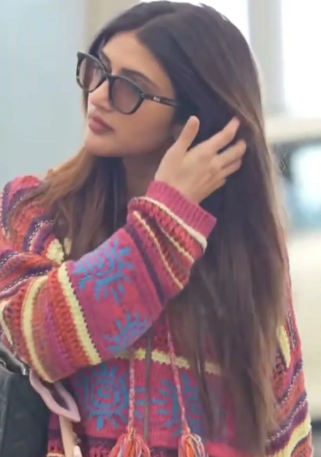 Sreeleela — Pushing her hair back: the blue sun motifs on the sleeve and the quilted chain bag