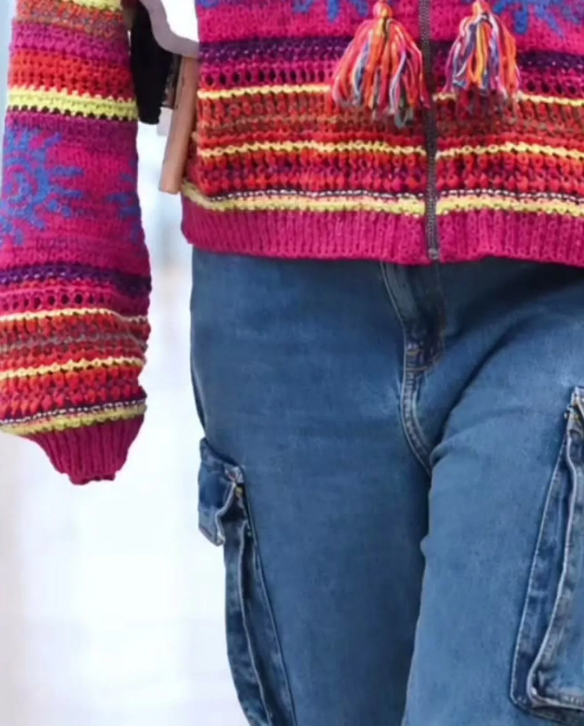 Sreeleela — The hem: tassels, the magenta rib, and a flap cargo pocket on each thigh